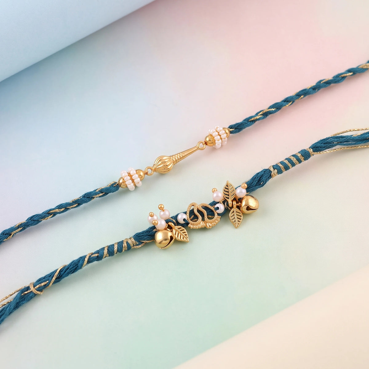 Hanuman Braided Charm Bhaiya Bhabhi Rakhi Set | Need Asthetic background in pastel range , only highlight both producut in pastel background , highly enaging and convertible i need this all three attached ima