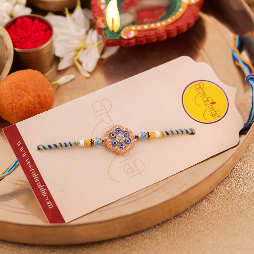 Handcrafted Royal Blue and Gold Floral Motif Rakhi zoom