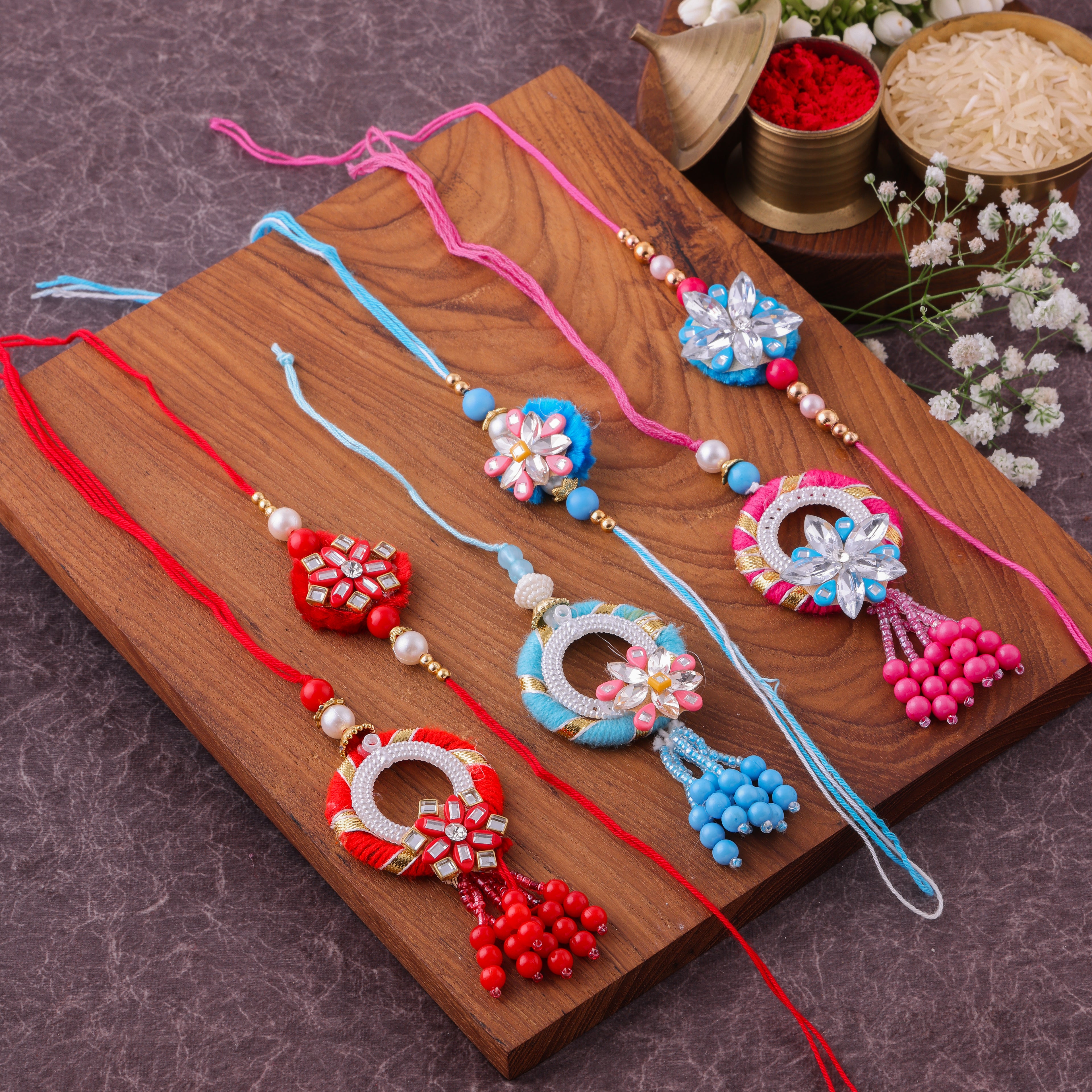 Vibrant Floral Pom Pom Bhai Bhabhi Couple Rakhi Set