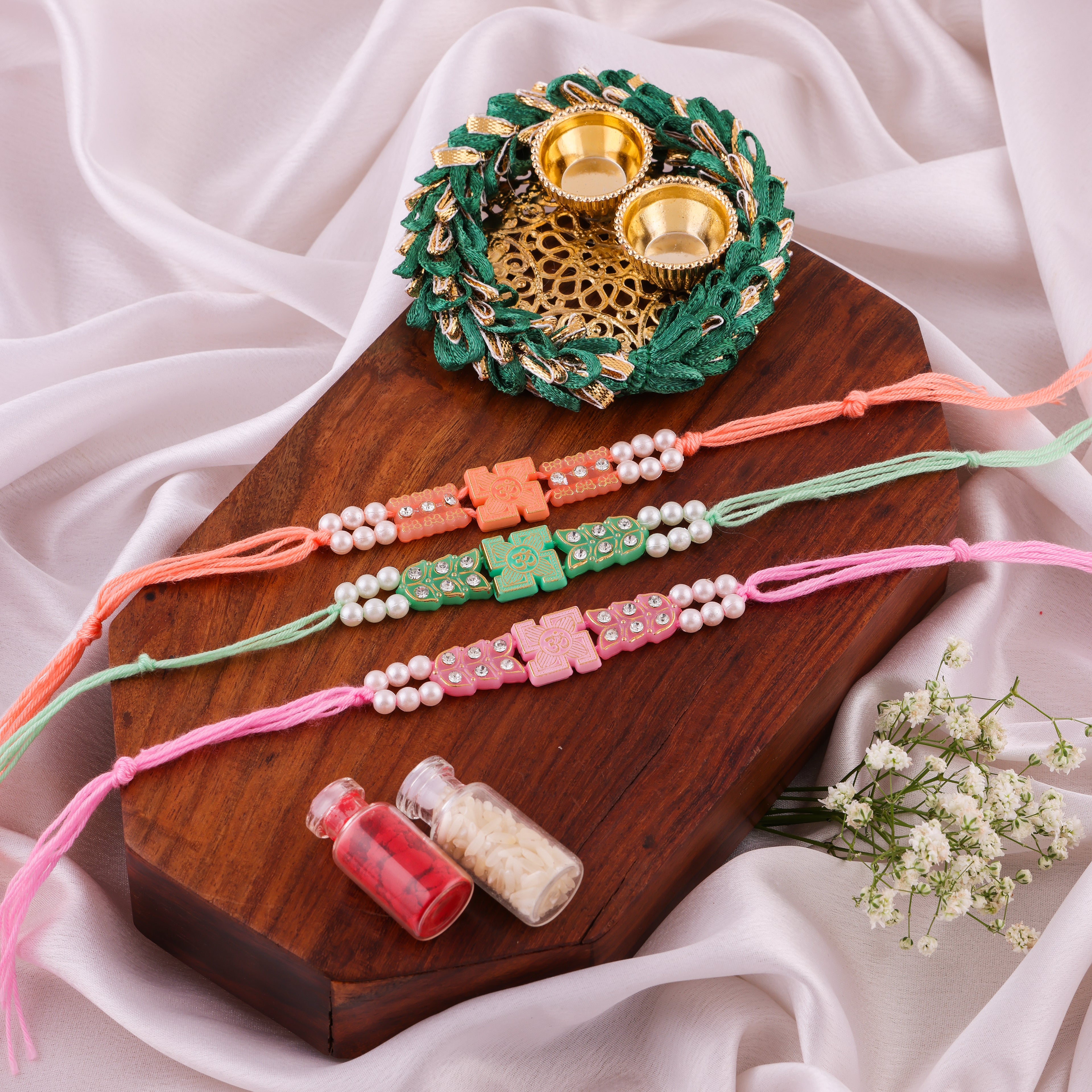 Om Cross Pearl Rakhi Combo - Pack of 3